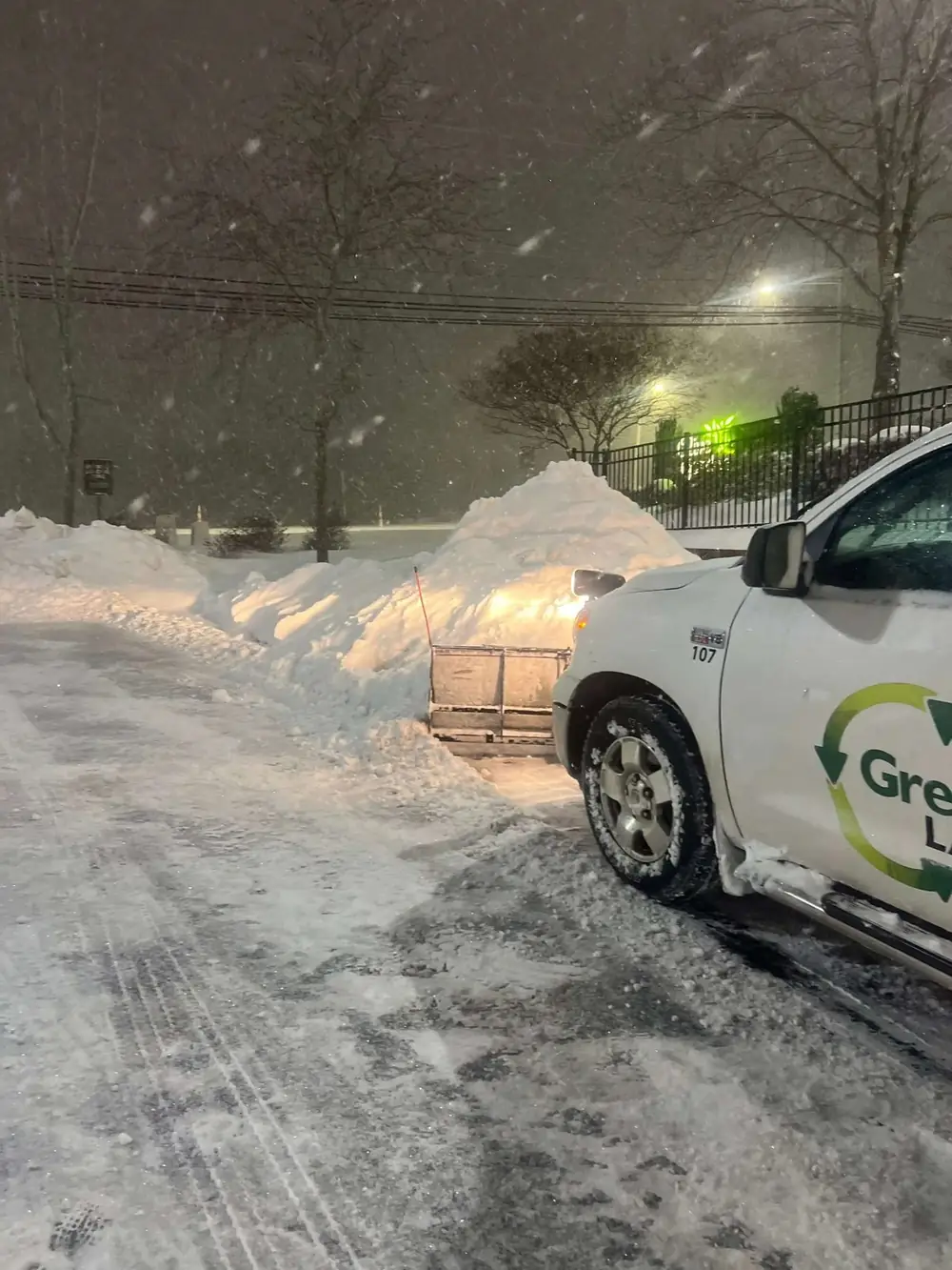Green & Clean plow truck clearing snow at a commercial property in Greensboro, NC